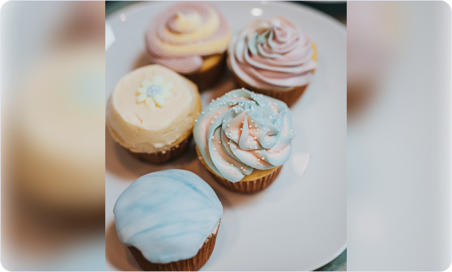 Decorated vanilla cupcakes on a plate