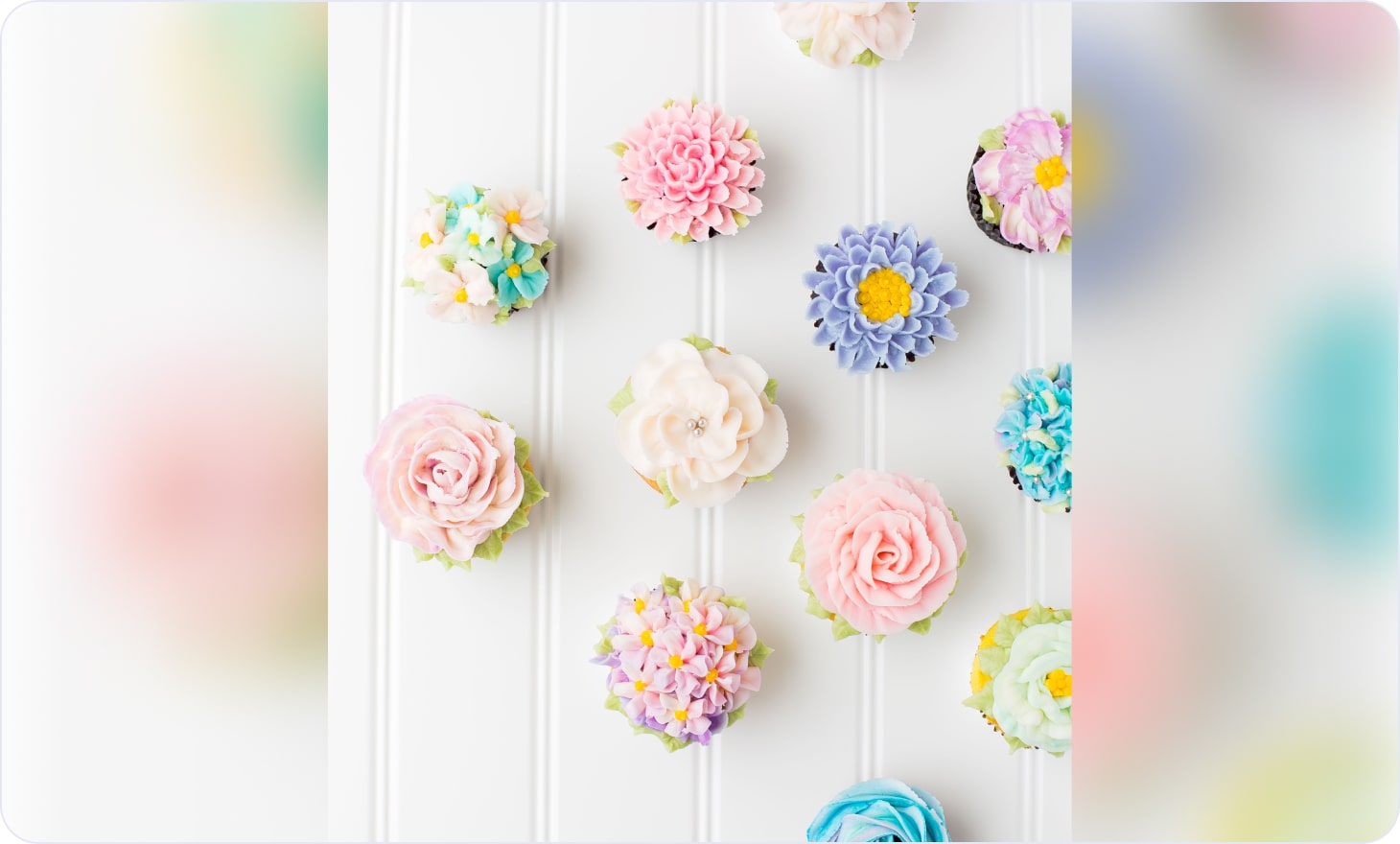 Decorated vanilla cupcakes in the shape of flowers