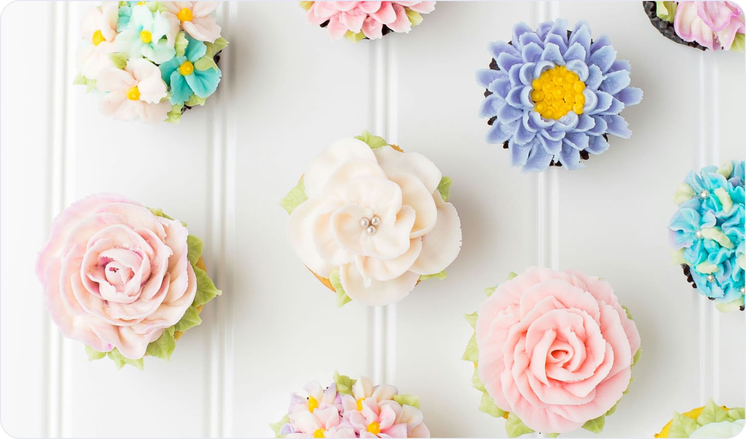 Decorating cupcakes with edible flowers