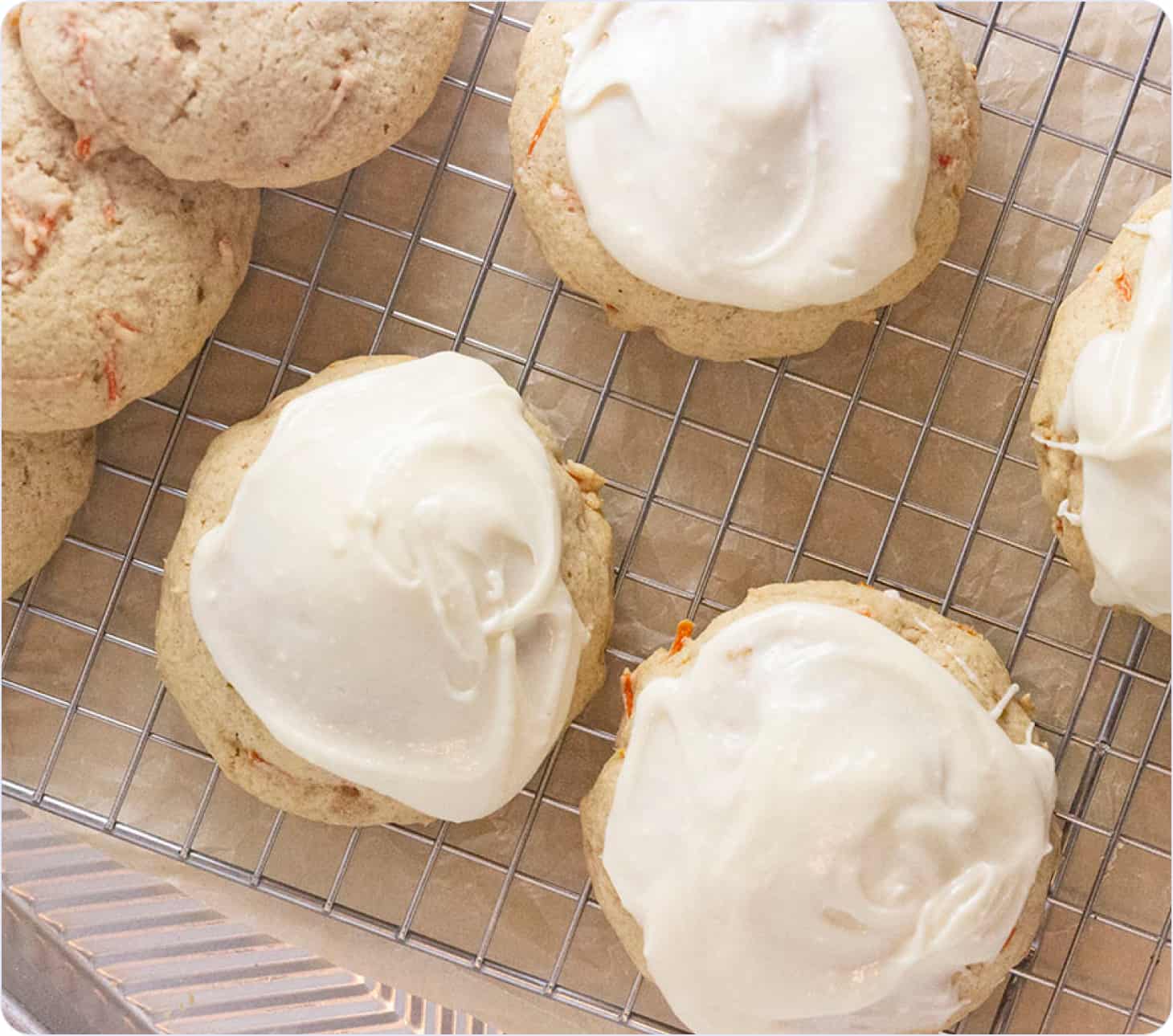 White cookies with icing on the grate