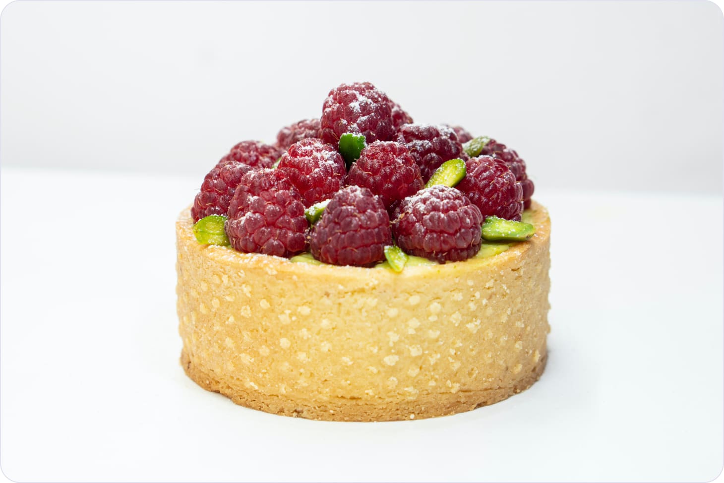 Cupcake decorated with raspberries and sprinkled with powdered sugar